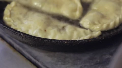 Flat patties with meat is fried in boiling oil in a frying pan Stock Footage 58853124