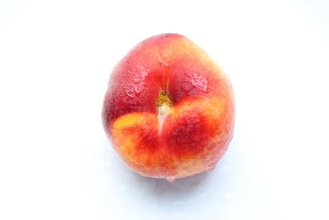 Flat peach isolated on white background. One fig peach in water drops. Fres.. Stock Photos