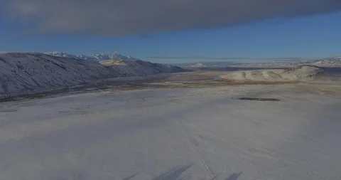 Flat Plains Aerial Surrounded By Mountains Snow Covered Field Winter Landscape Stock Footage 87234819