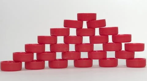 Flat pyramid, full of holes between the composite elements. made of the red.. Stock Photos