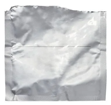 A flat, rectangular silver foil packaging sachet with a textured, crinkled .. Foto stock