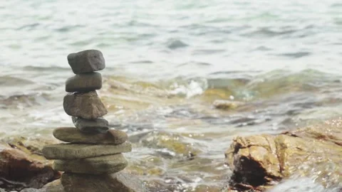 Flat Rock Stack on a Coastal Shoreline with Ocean Waves in the Background Stock Footage 343023725