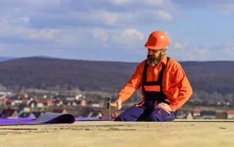 Flat roof installation. Roofer constructing new roof. Estimate materials 스톡 사진