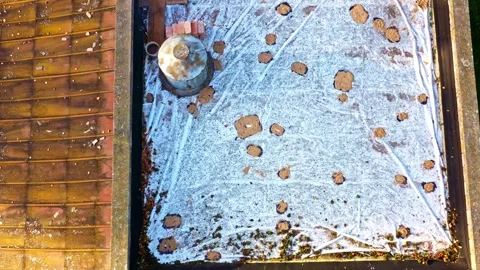 Flat roof showing ongoing membrane waterproofing with repair materials and Stock Footage 333870192
