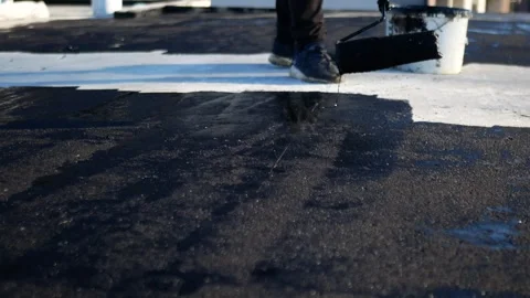 Flat roof waterproofing preparation using mastic primer close up Stock Footage 292935658
