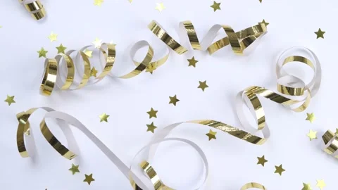 Flat rotating composition of golden ribbons or serpentine and golden confetti in Stock Footage 218283823