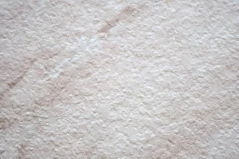 A flat, roughly finished surface of natural white marble with pink veins, clo Stock Photos
