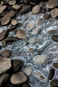 Flat rounded stones with rocks Stock Photos