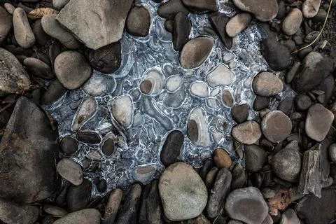 Flat rounded stones with rocks Stock Photos