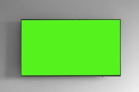 Flat screen TV with green chroma key display mounted on a gray white wall. Stock Photos