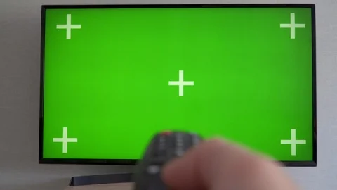 Flat screen TV with green screen composited Right Handed Man Searching TV Stock Footage 112373551