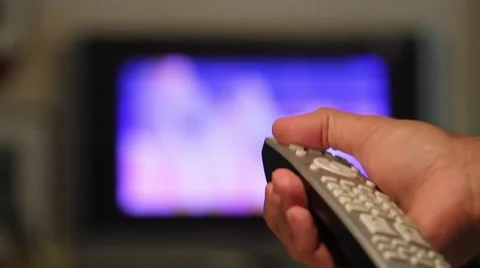 Flat screen TV, had comes into focus, hand with remote control and turns it off Stock Footage 45525302