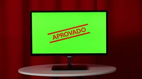 Flat screen TV. Standing on a white table. Green screen. Approved. Stamp. Red Vídeos de archivo 103176175