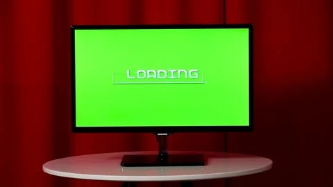 Flat screen TV. Standing on a white table. Green screen. Wait loading. Vídeos de archivo 103176585