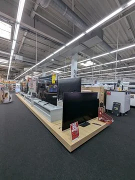 Flat-screen tvs displayed in electronics store interior side view with neutra Stock-Fotos
