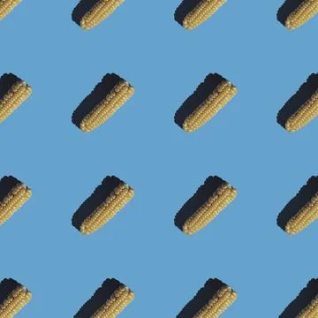 Flat seamless pattern of peeled corn on a blue background Stock Photos