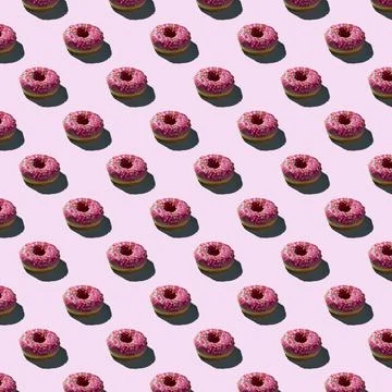 Flat seamless pattern of pink donuts on a warm background Stock Photos