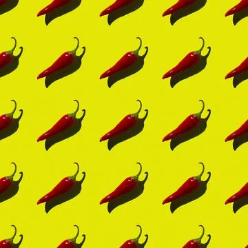 Flat seamless pattern of red hot pepper on a yellow background Stock Photos