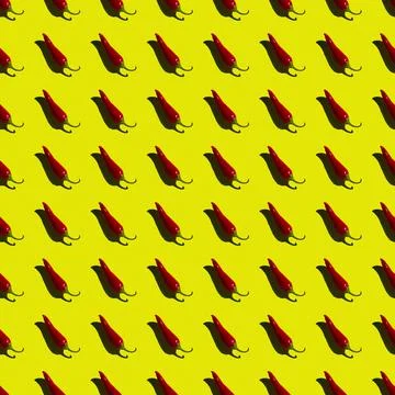 Flat seamless pattern of red hot pepper on a yellow background Stock Photos
