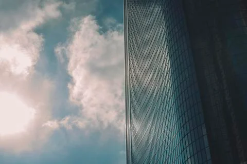 Flat Side of a Glass Sky Scraper with Sun and Clouds Stock Photos