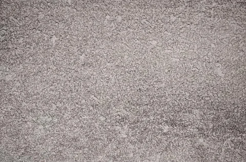 A flat surface of natural dark gray stone with traces of rough processing. Foto stock