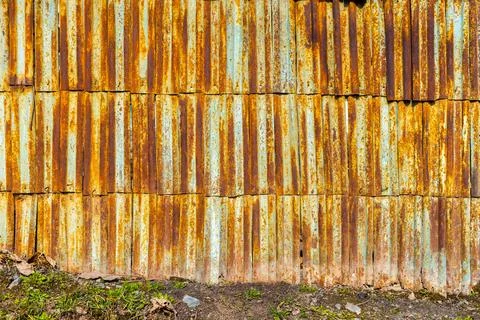 Flat texture of rustic fence made of rusted metal planks Stock Photos