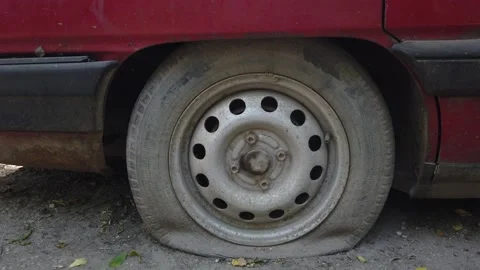 Flat tires on an old, rusty, wrecked Audi car. 動画素材 168419771