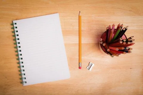 Flat top-down design showing blank spiral notebook on desk with pencil and 스톡 일러스트