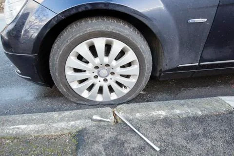 Flat tyre and broken spanner Stock Photos