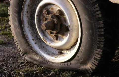 Flat tyre on vehicle stuck at the side of the road uk Stock Photos