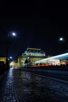 Flat vector is showing illuminated theatre with cobbled street and light trails Stock Photos