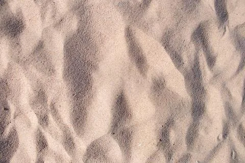 Flat view of clean yellow sand surface covering seaside beach. Sandy texture Stock Photos