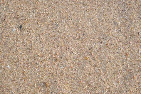 Flat view of clean yellow sand surface covering seaside beach. Sandy texture Foto stock