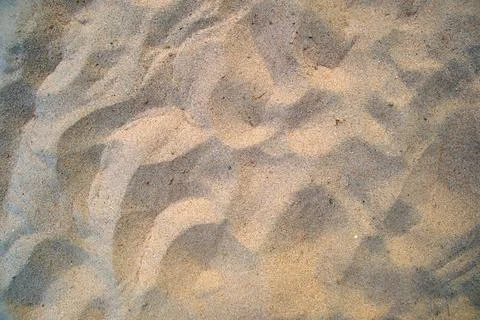 Flat view of clean yellow sand surface covering seaside beach. Sandy texture Stock Photos