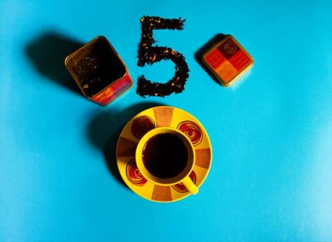 Flat view of tea time concept with colorful tea cup, tea container, loose bla Stock Photos