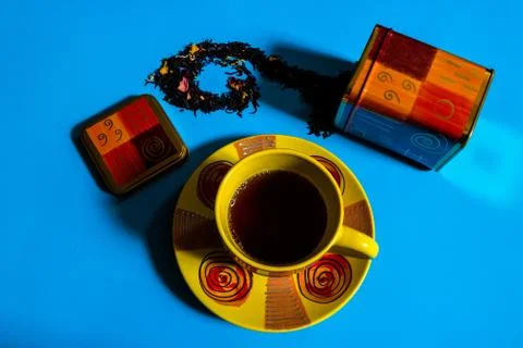 Flat view of tea time concept with colorful tea cup, tea container, loose bla Stock Photos