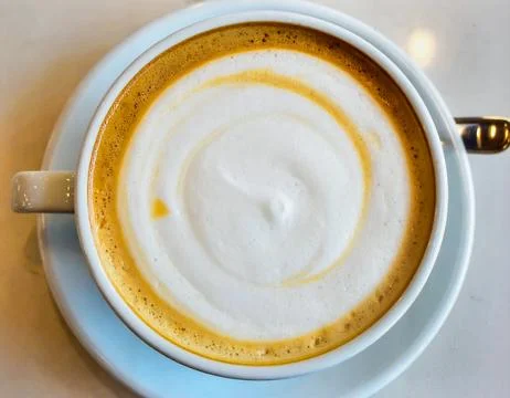 Flat White Coffee with Smooth Milk Foam Served in Ceramic Cup on Caf Table .. Stock Photos
