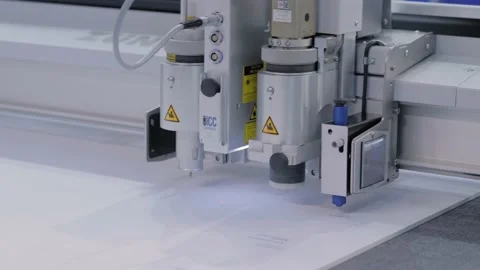 Flatbed cutter with drawing pen module writing text on white paper sheet Stock Footage 139987764