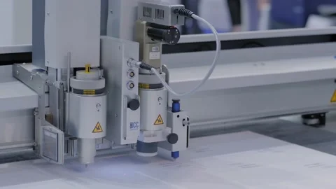 Flatbed cutter with drawing pen module writing text on white paper sheet Stock Footage 148497899
