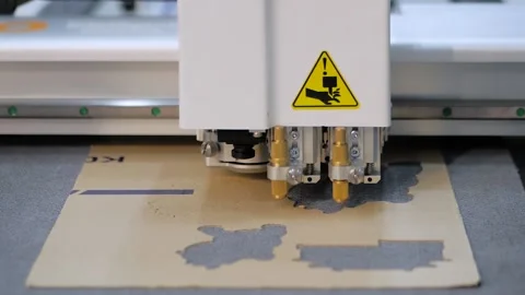 Flatbed cutter, plotter cutting cardboard sheet at exhibition: close up Stock Footage 148535351