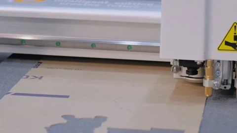 Flatbed cutter, plotter cutting cardboard sheet at printer exhibition Stock Footage 159911319