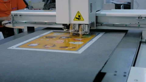 Flatbed cutter, plotter cutting label stickers at advertising exhibition Stock Footage 142960556