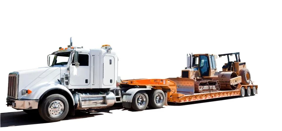 Flatbed hauling bulldozer and steamroller Stock Photos