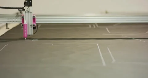 Flatbed Plotter Tracing Sewing Patterns on Grey Material, Low Angle Shot Stock Footage 341315339
