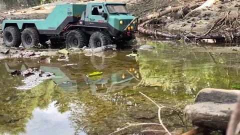 Flatbed towing truck going through forest puddle. Stock Footage 207404048