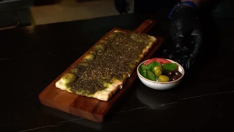 Flatbread with Pesto and Olives Stock Footage 319950343