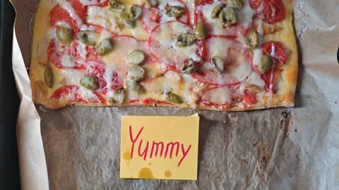 A flatbread is placed on a baking sheet, topped with an assortment of fresh Stock-Footage 339096474