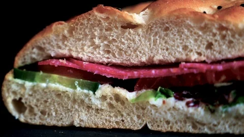 Flatbread sandwich with salami tomato cucumber salad and gravy 1 Stock Footage 120706195