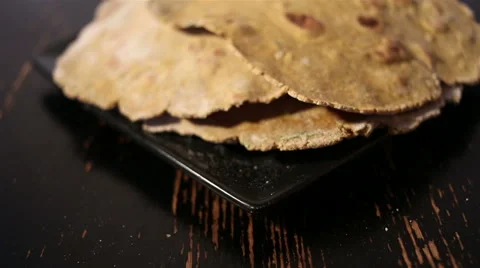 Flatbreads on the black plate Stock Footage 67479369