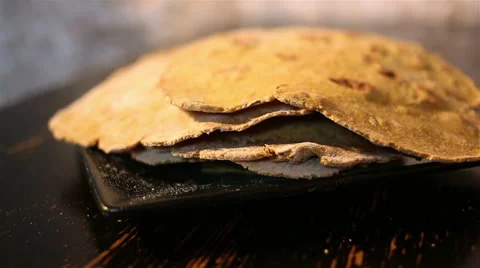 Flatbreads on the black plate Video stock 67479417